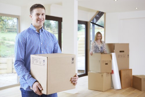Moving team carrying household items from a flat in Ealing