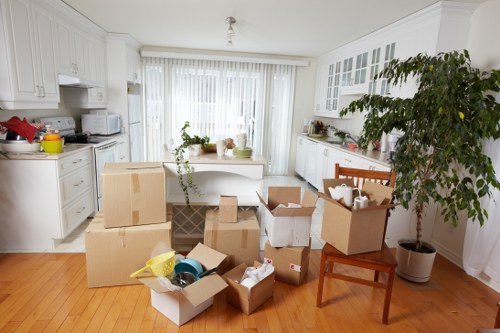 Office furniture and packed boxes prepared for a local Ealing move
