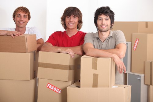 Packed moving boxes and furniture ready for transport in West London