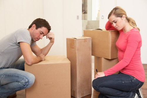 Professional movers handling furniture in a local Ealing property