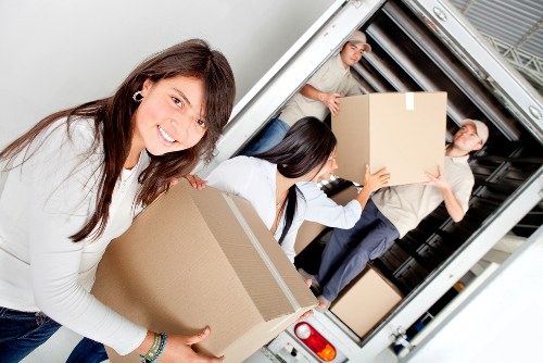 Furniture being carried through a residential property in Ealing