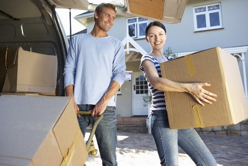 Moving team handling furniture in a flat near Ealing Broadway