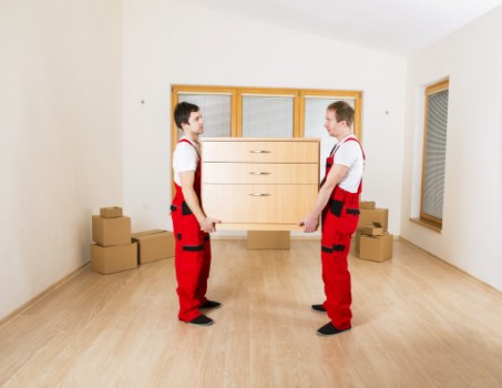 Professional movers loading boxes for a local move in Ealing